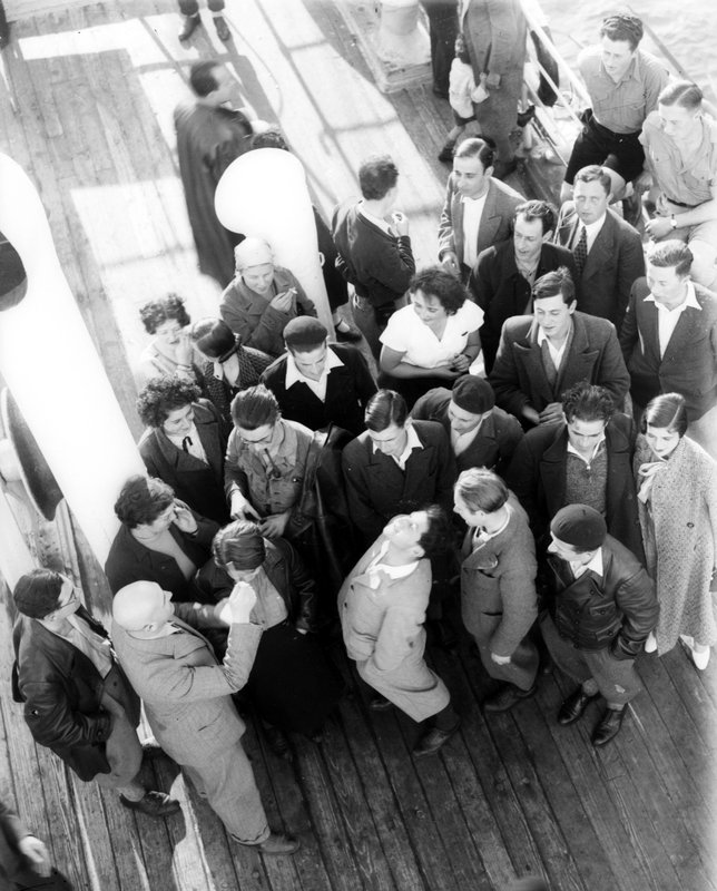 German-Jewish immigrants of the Fifth Aliyah on a ship's deck approaching Jaffa port, 1933